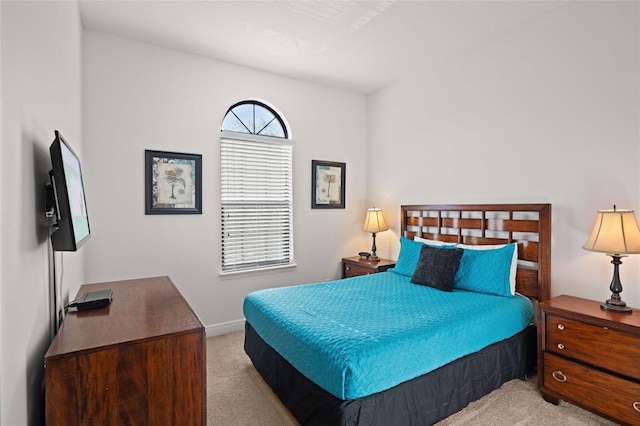 bedroom featuring light colored carpet