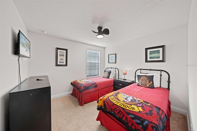 bedroom featuring light carpet, a textured ceiling, and ceiling fan