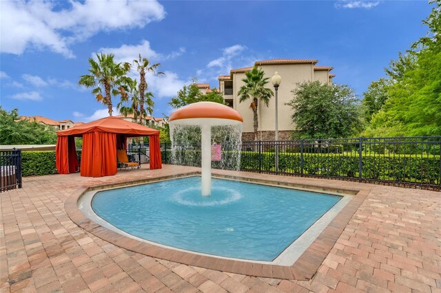 view of swimming pool with a patio and a gazebo