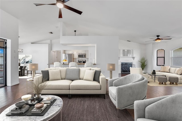 living room with dark hardwood / wood-style floors, ceiling fan, and high vaulted ceiling