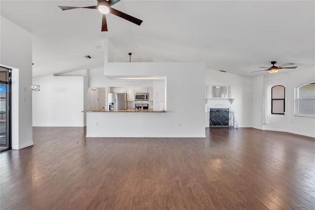 unfurnished living room featuring ceiling fan, dark wood-type flooring, and high vaulted ceiling