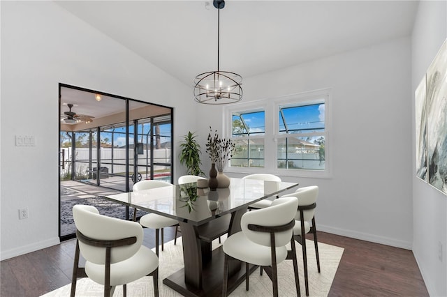 dining room with dark hardwood / wood-style floors and ceiling fan with notable chandelier