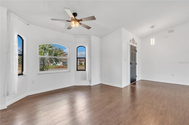 unfurnished room with ceiling fan, dark hardwood / wood-style flooring, and vaulted ceiling