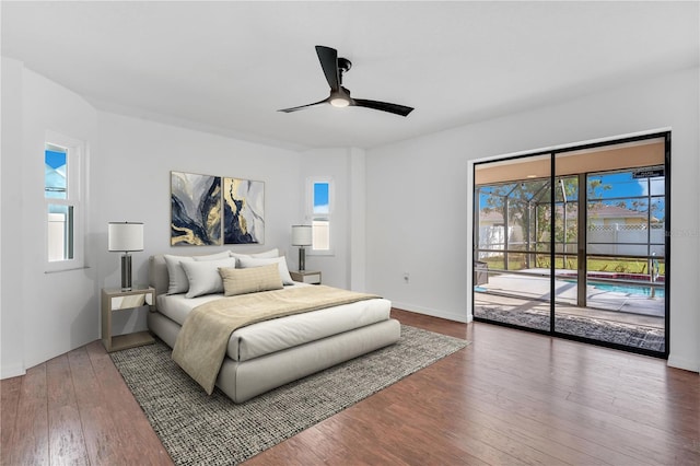 bedroom featuring access to exterior, ceiling fan, and dark wood-type flooring