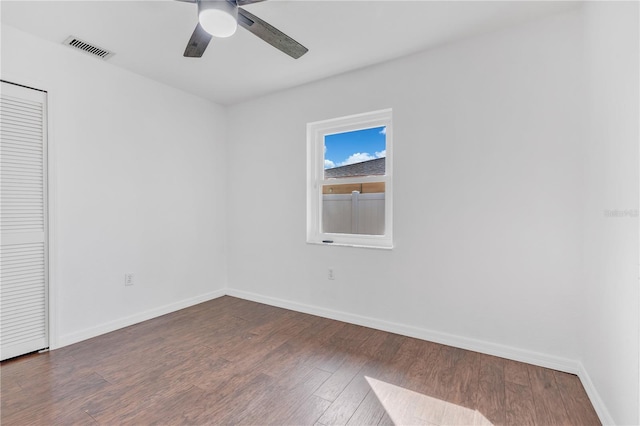 empty room featuring ceiling fan and dark wood-type flooring