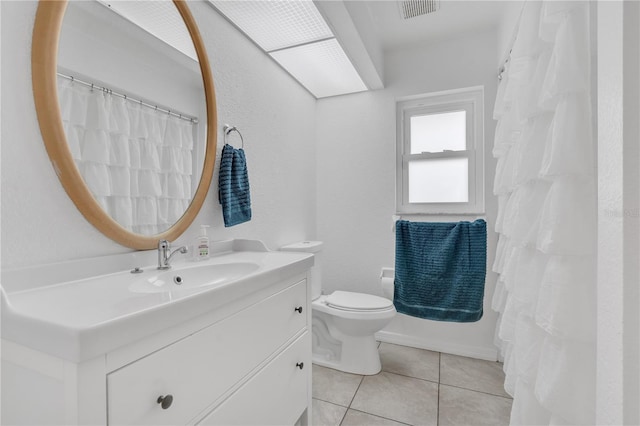 bathroom featuring tile patterned flooring, vanity, and toilet