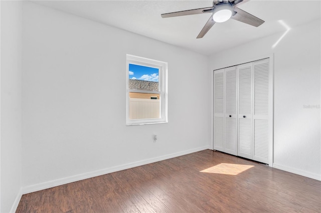 unfurnished bedroom with ceiling fan, a closet, and hardwood / wood-style flooring