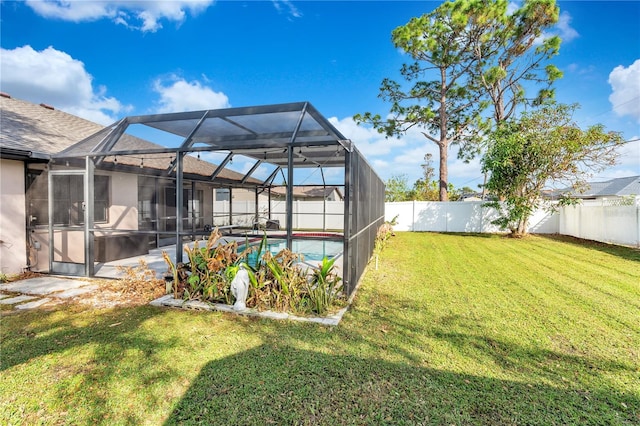 view of yard featuring a fenced in pool and glass enclosure