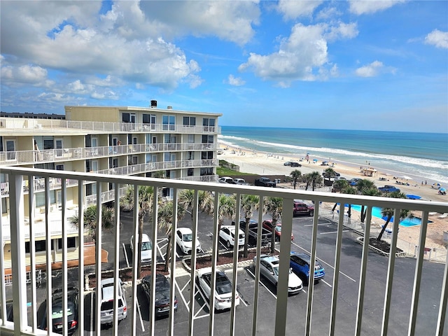 balcony featuring a water view and a view of the beach