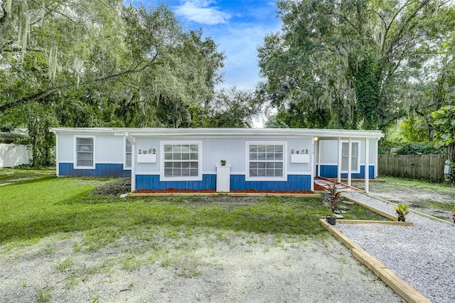 single story home with a front yard and a porch