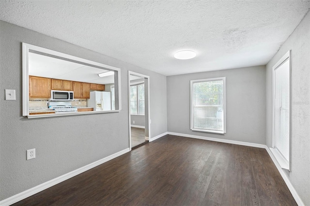 unfurnished living room with a textured ceiling and dark wood-type flooring