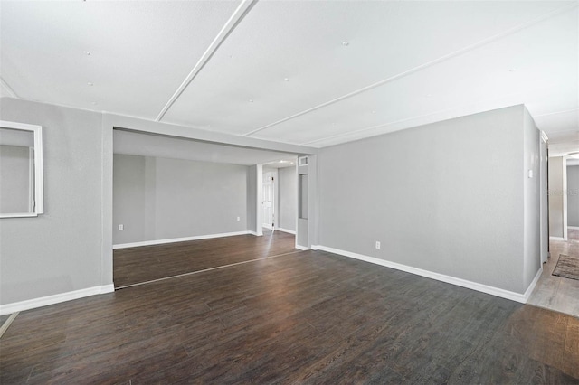 unfurnished room with dark hardwood / wood-style floors