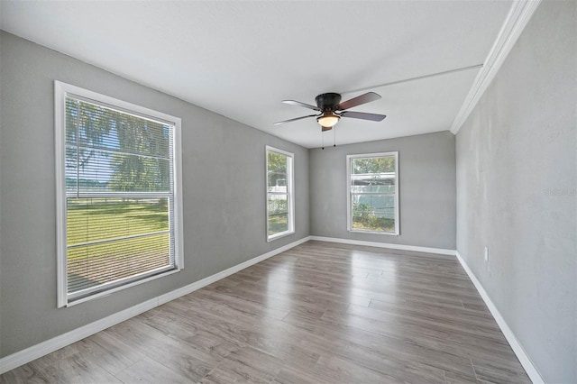 unfurnished room with ornamental molding, hardwood / wood-style floors, and ceiling fan