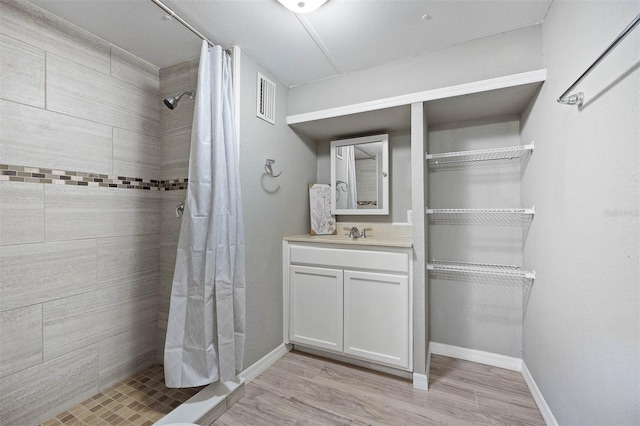 bathroom with vanity, hardwood / wood-style floors, and curtained shower