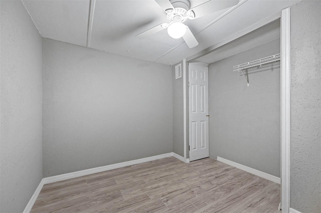 unfurnished bedroom featuring ceiling fan, a closet, and light hardwood / wood-style flooring