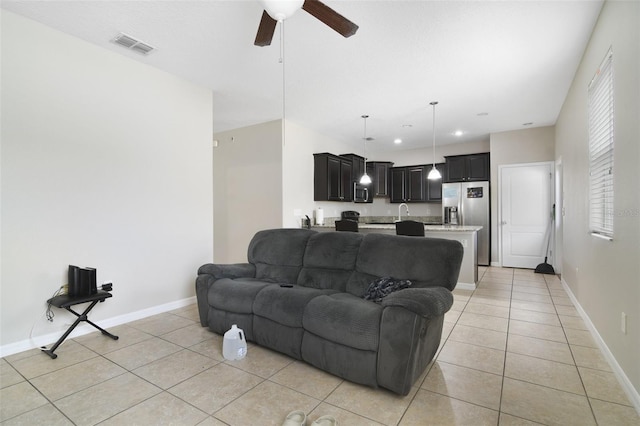 living room with ceiling fan and light tile patterned floors