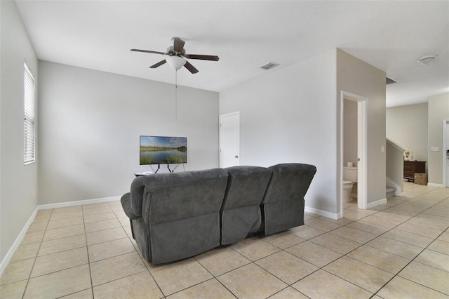 living room with ceiling fan and light tile patterned floors