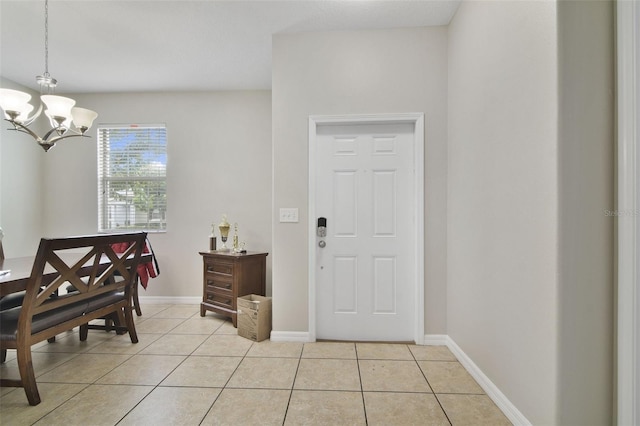 entrance foyer with an inviting chandelier and light tile patterned floors