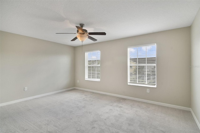 unfurnished room with light carpet, ceiling fan, and a textured ceiling