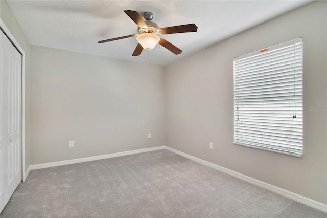 carpeted empty room with ceiling fan