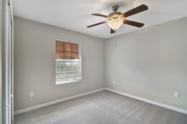 empty room with light carpet and ceiling fan