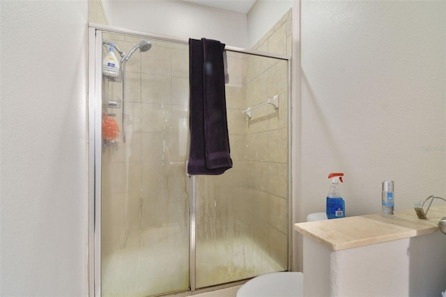 bathroom with an enclosed shower and toilet