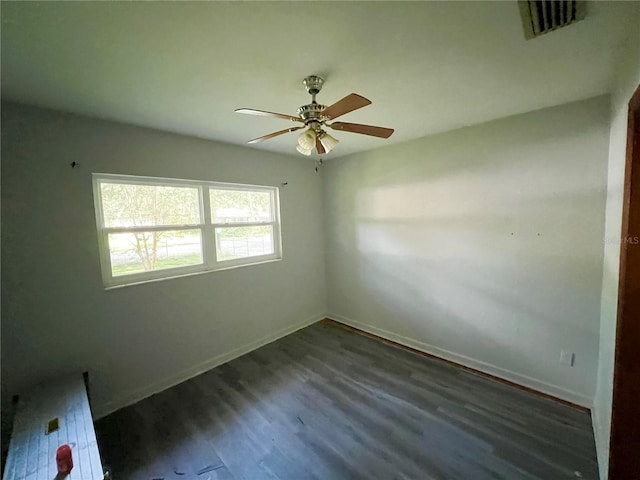 unfurnished room with ceiling fan and dark hardwood / wood-style floors