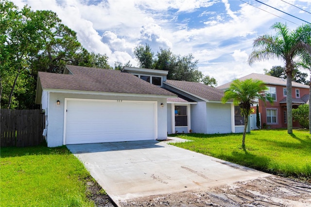 view of front of home with a front lawn and a garage