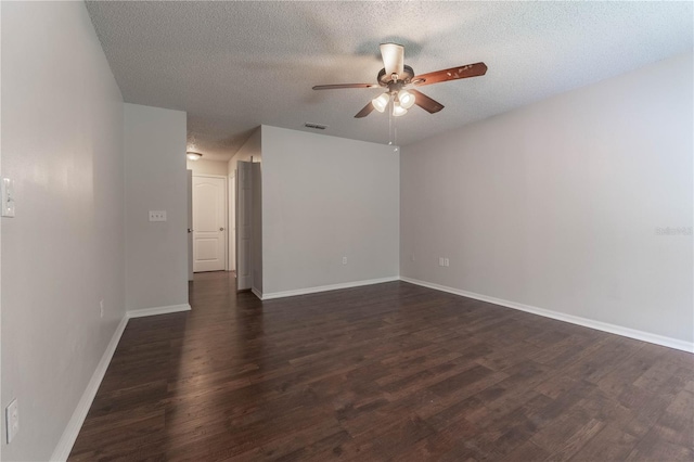 spare room with ceiling fan, a textured ceiling, and dark hardwood / wood-style flooring