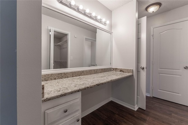 bathroom featuring vanity, hardwood / wood-style floors, and a textured ceiling