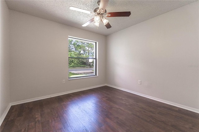 empty room with a textured ceiling, dark hardwood / wood-style floors, and ceiling fan