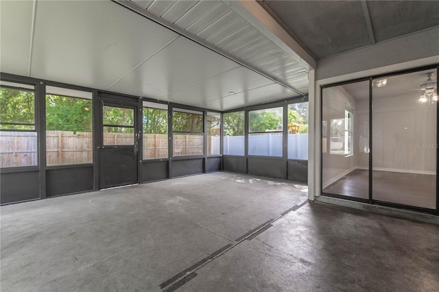 unfurnished sunroom with ceiling fan