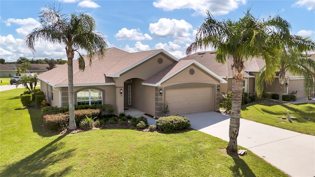 view of front of house featuring a front yard and a garage