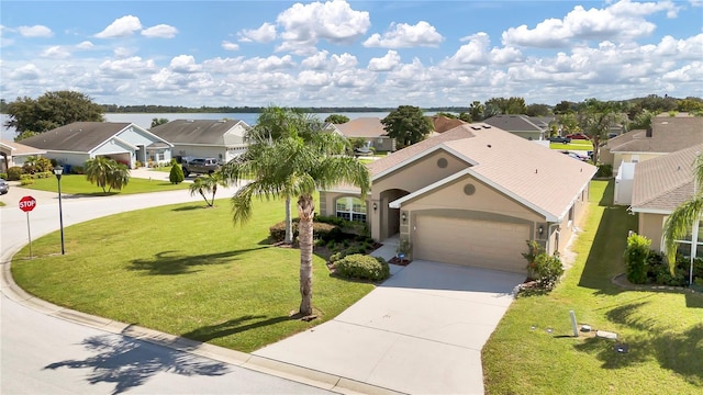 view of front of property with a water view, a garage, and a front yard