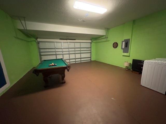 playroom with electric panel, pool table, and a garage