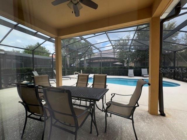pool with ceiling fan, a patio, and glass enclosure