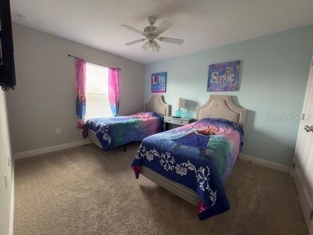 bedroom with ceiling fan, carpet floors, and baseboards