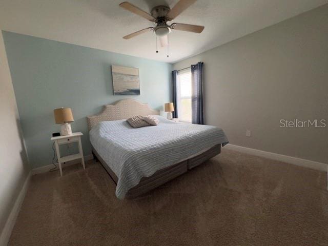 carpeted bedroom with a ceiling fan and baseboards