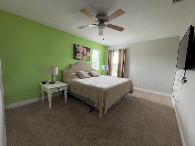 bedroom with ceiling fan, light carpet, and baseboards