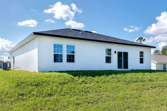 rear view of property with a yard and cooling unit