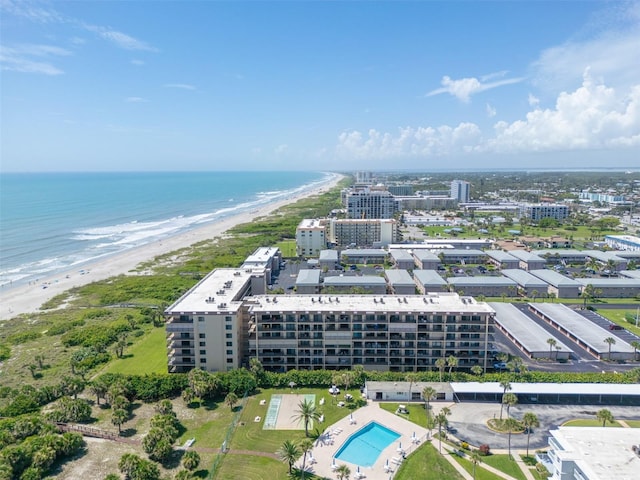 birds eye view of property featuring a beach view and a water view