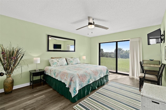 bedroom featuring ceiling fan, a textured ceiling, access to outside, and dark wood-type flooring