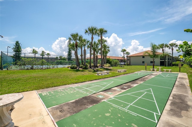 view of property's community with a yard and a water view