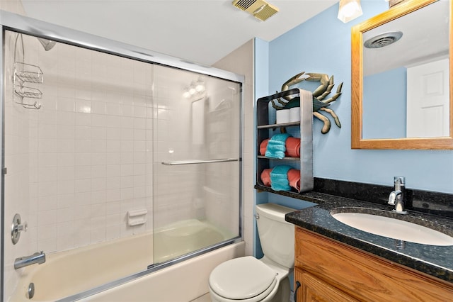 full bathroom featuring bath / shower combo with glass door, toilet, and vanity