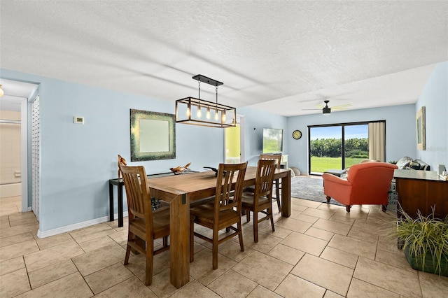 tiled dining area featuring ceiling fan and a textured ceiling