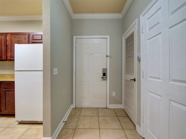 entrance foyer with light tile patterned floors and ornamental molding