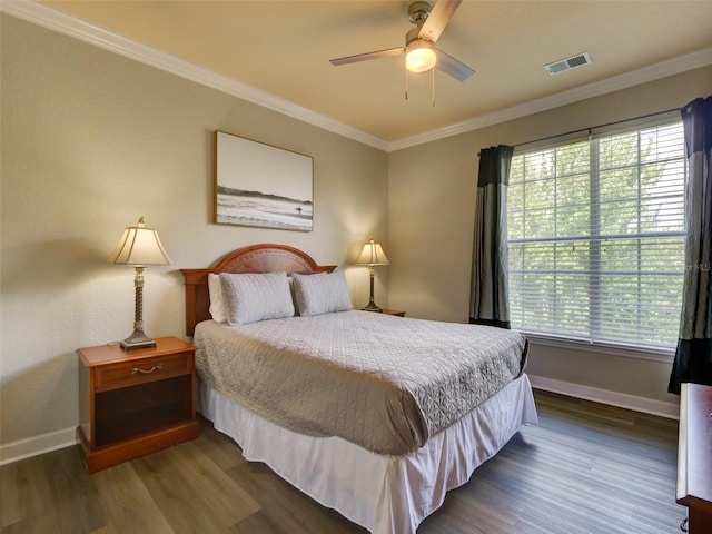 bedroom with ceiling fan, ornamental molding, and dark wood-type flooring