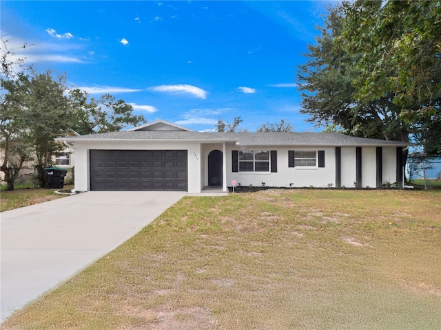 ranch-style home featuring a garage and a front lawn