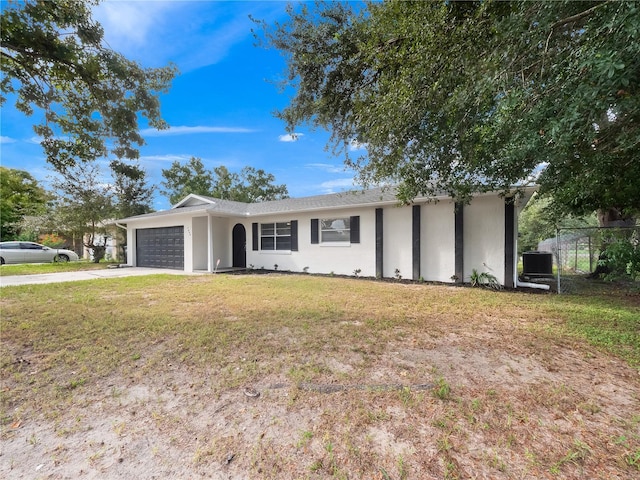 5400 Fox Briar Trl, Orlando, FL 32808 - single story home featuring central air condition unit, a garage, stucco siding, a front yard, and driveway