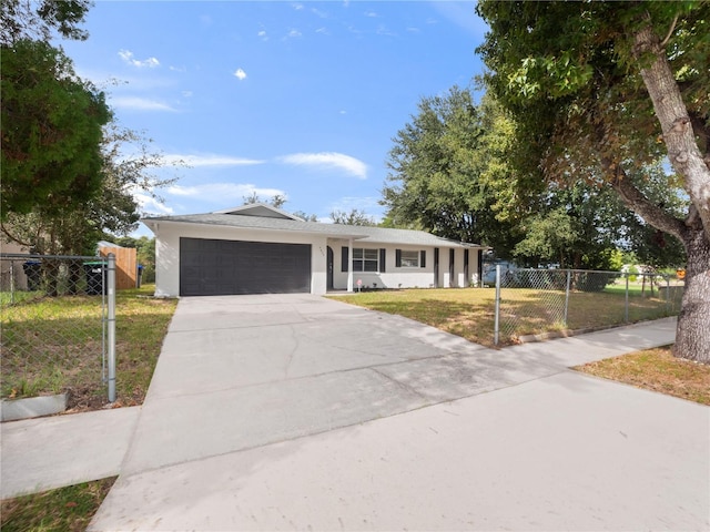 single story home featuring a front lawn and a garage